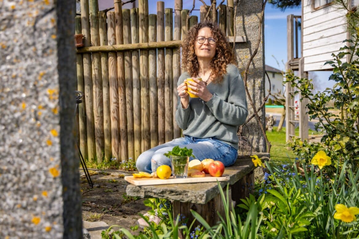 Frau genießt Kaffee im Garten