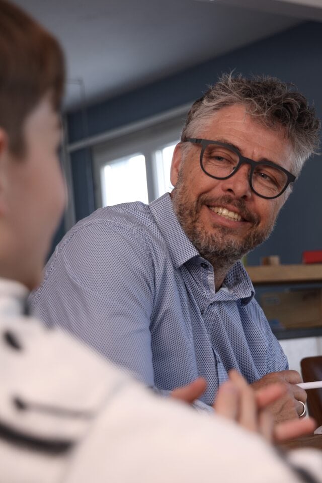 Mann im Gespräch am Tisch